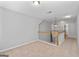 Upstairs hallway with neutral walls, plush carpet, and white railing overlooking the staircase below at 4654 Liberty Square Dr, Acworth, GA 30101