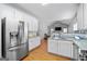 An open-concept kitchen features stainless appliances and a view of the adjacent living room at 4654 Liberty Square Dr, Acworth, GA 30101
