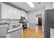 The kitchen offers stainless appliances, white cabinets and a clear view into the adjacent room at 4654 Liberty Square Dr, Acworth, GA 30101