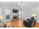 Bright living room features a vaulted ceiling, brick fireplace, and gleaming hardwood floors at 4654 Liberty Square Dr, Acworth, GA 30101