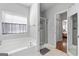 Well-lit bathroom with a separate soaking tub, shower, and neutral color scheme at 4654 Liberty Square Dr, Acworth, GA 30101
