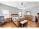 Spacious main bedroom featuring hardwood floors, ceiling fan, and a cozy quilted bed set at 4654 Liberty Square Dr, Acworth, GA 30101