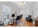 Bright office space featuring hardwood floors, a ceiling fan, and two workstations at 4654 Liberty Square Dr, Acworth, GA 30101