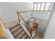 Bright staircase with carpeted steps and white railing leads to the upper level with windows and hardwood floors at 4654 Liberty Square Dr, Acworth, GA 30101