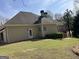 Residential home with a fenced backyard, featuring a deck and a well-maintained lawn at 9039 River Bend Ct, Villa Rica, GA 30180