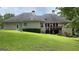 Beautiful backyard with a screened porch, deck, well-maintained lawn, and mature trees for shade and privacy at 9039 River Bend Ct, Villa Rica, GA 30180