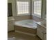 Bright bathroom features a soaking tub with dual vanities and tiled surround at 9039 River Bend Ct, Villa Rica, GA 30180