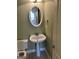 Charming half bathroom with pedestal sink, decorative mirror, and toilet at 9039 River Bend Ct, Villa Rica, GA 30180