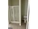 Bathroom featuring a white shower stall with sliding glass doors and a toilet at 9039 River Bend Ct, Villa Rica, GA 30180