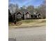 Beautiful brick home with arched windows, trimmed hedges, and a professionally landscaped front yard for curb appeal at 9039 River Bend Ct, Villa Rica, GA 30180
