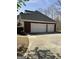 Attached three-car garage with paved driveway at 9039 River Bend Ct, Villa Rica, GA 30180