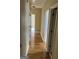 Hallway features hardwood flooring, neutral walls, and access to multiple rooms at 9039 River Bend Ct, Villa Rica, GA 30180
