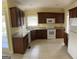 Spacious kitchen with tile flooring, dark cabinets, and modern appliances at 9039 River Bend Ct, Villa Rica, GA 30180