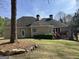 Lovely home exterior featuring a dark roof, neutral siding, and a deck with stairs to the yard at 9039 River Bend Ct, Villa Rica, GA 30180