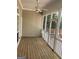 Screened porch with wood flooring, ceiling fan, and outdoor access, great for entertaining at 9039 River Bend Ct, Villa Rica, GA 30180