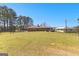 Spacious backyard featuring a brick home with a deck and a lush, green lawn at 275 S Bethany Rd, Mcdonough, GA 30252