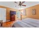 Bedroom showcasing hardwood floors, a ceiling fan, and a TV with dresser storage for entertainment and organization at 275 S Bethany Rd, Mcdonough, GA 30252
