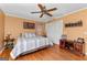 Bedroom featuring hardwood floors, ceiling fan, and storage furniture, blending comfort and functionality at 275 S Bethany Rd, Mcdonough, GA 30252