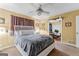 Bright bedroom with a white bed frame and ceiling fan, connected to another room via a decorated archway at 275 S Bethany Rd, Mcdonough, GA 30252