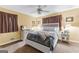 Comfortable bedroom featuring neutral walls, plush carpet, and a ceiling fan for added air circulation at 275 S Bethany Rd, Mcdonough, GA 30252