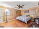 Spacious bedroom with hardwood floors, a ceiling fan, and a comfortable bed, perfect for relaxation at 275 S Bethany Rd, Mcdonough, GA 30252
