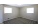 Inviting bedroom featuring neutral paint, carpet, and two bright windows at 1751 Woodsloe Dr, Decatur, GA 30035