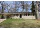Charming brick home featuring a well-maintained lawn and a convenient carport at 1751 Woodsloe Dr, Decatur, GA 30035