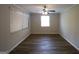 Comfortable bedroom featuring wood-look floors, bright light, and neutral wall paint at 2096 Dellwood Pl, Decatur, GA 30032