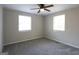 Bright bedroom featuring two windows, plush carpeting, and a modern ceiling fan at 2096 Dellwood Pl, Decatur, GA 30032