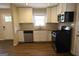 Bright kitchen features stainless appliances, updated white cabinets, and tile backsplash at 2823 Horse Shoe Dr, Atlanta, GA 30316