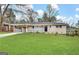 Charming brick home featuring a well-manicured lawn and a covered front porch at 3065 Glendale Ct, Decatur, GA 30032