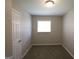 Cozy bedroom with neutral carpet, natural light and ample closet space at 4044 Lindsey Dr, Decatur, GA 30035