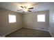 Bright bedroom with carpet, multiple windows providing natural light, and a ceiling fan at 4044 Lindsey Dr, Decatur, GA 30035