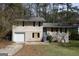 Two-story house with a garage, front lawn, and some trees around the house at 4044 Lindsey Dr, Decatur, GA 30035