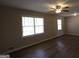 Bright living room with hardwood floors, ceiling fan and natural light from a large window at 4044 Lindsey Dr, Decatur, GA 30035