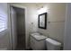 Clean bathroom featuring a vanity with granite countertop, framed mirror, and a toilet at 767 San Miguel Dr, Stone Mountain, GA 30083