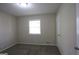 Cozy bedroom features neutral walls, carpet, a window, and a closet for storage at 767 San Miguel Dr, Stone Mountain, GA 30083