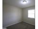 Simple bedroom with neutral walls, carpet flooring, and a window providing natural light at 767 San Miguel Dr, Stone Mountain, GA 30083