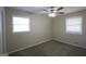 Bedroom featuring neutral walls, carpet flooring, and two windows for natural light at 767 San Miguel Dr, Stone Mountain, GA 30083