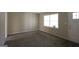 Bright living room featuring neutral paint, plush carpeting, and a large window allowing ample natural light at 767 San Miguel Dr, Stone Mountain, GA 30083