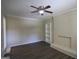 Spacious living room with wood flooring, painted brick fireplace, built-in shelving, and a modern ceiling fan at 767 San Miguel Dr, Stone Mountain, GA 30083