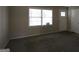 Bright living area featuring neutral carpeting, a large window, and fresh paint, creating a welcoming space at 767 San Miguel Dr, Stone Mountain, GA 30083