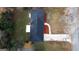 Aerial view of a house with a large backyard and a driveway with car at 1351 John Robert Dr, Morrow, GA 30260