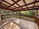 Outdoor back deck with tile flooring, wood railing, and a covered roof at 1351 John Robert Dr, Morrow, GA 30260