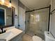 Updated bathroom featuring a frameless glass shower, sleek fixtures, and marble-look tile at 1351 John Robert Dr, Morrow, GA 30260