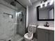Updated bathroom with a new glass shower, modern fixtures, and gray cabinets at 1351 John Robert Dr, Morrow, GA 30260