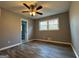 Bedroom features wood floors, two windows, and a ceiling fan at 1351 John Robert Dr, Morrow, GA 30260