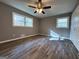 Inviting bedroom featuring wood-look flooring and natural light from two windows at 1351 John Robert Dr, Morrow, GA 30260