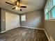 Cozy bedroom with wood-look flooring, neutral walls, and a ceiling fan for added comfort at 1351 John Robert Dr, Morrow, GA 30260