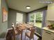 Virtual staging of a dining area with a table and four chairs in a room with natural light at 1351 John Robert Dr, Morrow, GA 30260
